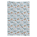 A rectangular swaddle blanket with a repeating pattern of blue and brown mountains, clouds, birds, and the text 'COLTON Joseph' on a light blue background.