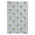 Personalized pale blue swaddle blanket with white daisy bouquets, scattered flowers, green leaves, and the name Charlotte Mae.