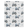 Personalized Blue Tractor Baby Boy Blanket. Blue tractors bring a playful countryside touch to a custom name on a white background.