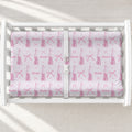A white changing table with a personalized changing pad cover featuring a pink ballet dancer pattern, including bows, leaping figures, and the name 'Elizabeth' printed in script.