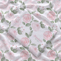 Folded Blush Rose Garden swaddle blanket showing pink watercolor roses, sage leaves, and Elizabeth Rose in pink and green lettering.