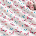 Personalized Pink and Aqua Butterfly Baby Girl Blanket. Pink butterflies, aqua leaves, and delicate flowers surround a custom name on a bright white background.