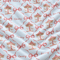 A close-up of a white fabric with a repeating pattern of gold and red carousel illustrations, pink ribbon bows, and the name 'Emery' in cursive script.