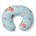 A U-shaped nursing pillow in light blue with a watercolor holiday print featuring red vintage cars, bunnies, snowmen, and Christmas trees, with the text 'SIENNA rose' printed in red.