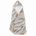 Baby hooded towel featuring yellow construction vehicles, traffic cones, bricks, blue clouds, and the name Macallan in gray lettering.