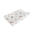 A custom baby changing pad cover featuring a white background with a repeating pattern of colorful dirt bikes, race flags, and the name 'CARTER' printed in brown.