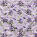 Pale lavender swaddle blanket with purple violet flowers, green leaves, and the name Violet Mae in purple and green lettering.