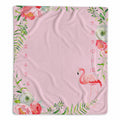 A pink milestone blanket with a watercolor design featuring a flamingo, green foliage, and pink and white flowers, with printed numbers 1 through 12 along the left and right edges.