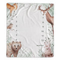 A square baby growth chart blanket featuring watercolor-style woodland animal illustrations including a deer, bear, rabbit, bird, and fox around a large central space marked for months 1 through 12.