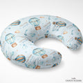 A U-shaped baby nursing pillow with a light blue background and an all-over print of hot air balloons, clouds, stars, and the name 'Colton' in script. The brand 'CAIDEN DESIGNS' is visible in the bottom right corner.