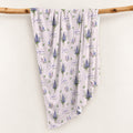 Pale blush swaddle blanket with blue and lavender larkspur bouquets, green leaves, and the name Sophia Kate in blue and green.