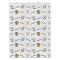 A white blanket featuring a repeating pattern of baseball-themed illustrations, including baseball uniforms, gloves, bats, and the name 'Jackson' in blue script.