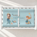 A white changing table with a personalized changing pad cover featuring watercolor mermaid illustrations.