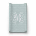 A personalized soft mint baby changing pad cover featuring a white monogrammed 'PME' design inside a circle with a repeating 'PALMER' personalization pattern.