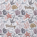 A repeating nautical pattern on a white background featuring gray anchors, purple seashells, pink starfish, coral, bubbles, and the name 'Finley' in brown script.