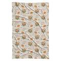 Cream swaddle blanket with golden-orange marigold clusters, green leaves, and the name Autumn Grace in orange and green.