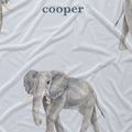 Close-up of Little Elephant fabric showing a detailed gray watercolor elephant and Cooper in slate blue lettering on pale blue.