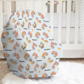 Monster Trucks baby car seat cover personalized with Ryder, featuring colorful watercolor trucks and flames on pale blue in a bright nursery.