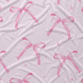 Blush pink fabric with watercolor bows, tiny sparkles.