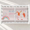 A white changing table with a personalized changing pad cover featuring a white unicorn, rainbow, and stars, featuring the name 'ELIZABETH GRACIE' in blue and pink lettering.