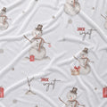 White fabric with a repeating pattern of watercolor snowmen, small red gift boxes, gray dots, and the personalized text 'JACK wyatt' in red and black script.