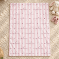 A pink and white striped baby blanket with the name 'sophia' and small hearts printed repeatedly, laid flat on a beige shag rug with a stuffed bunny and pink booties nearby.