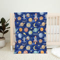 Full view of the Space Explorers personalized blanket with white Scout lettering and colorful watercolor space illustrations on a navy starry background.