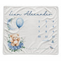 Baby boy milestone blanket personalized with Liam Alexander, featuring a teddy bear, blue balloon, floral moon, and monthly number grid.
