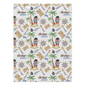 A personalized blanket featuring a pirate-themed pattern with palm trees, treasure maps, ship's wheels, and the custom text 'Archer JAMES' printed repeatedly on a white background.