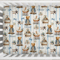 A crib bedding set featuring a repeating pattern of teddy bears, baby carriages, and the name 'Oliver' on blue and white vertical stripes, shown inside a white wooden crib.