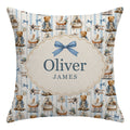 Personalized square throw pillow featuring a vintage teddy bear and airplane pattern on a light blue and white striped background, with a central cream-colored oval frame containing the names 'Oliver' and 'JAMES' under a blue bow.