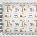 Close-up of Wildwood Safari crib sheet with watercolor giraffes, elephants, lions, zebras, and the name Oliver in olive green.