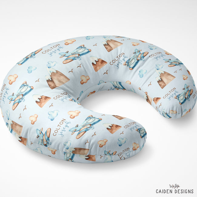 A U-shaped maternity pillow with a light blue background and a repeating print of teddy bears, mountains, and the text 'COLTON JOSEPH'.