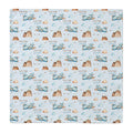 A square swaddle blanket featuring a repeating watercolor pattern of blue airplanes, brown mountains, and beige clouds on a light blue background, with the name 'COLTON joseph' printed repeatedly.