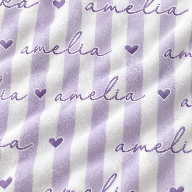 A close-up of a fabric surface with vertical lavender and white stripes, overlaid with repeated cursive 'amelia' text and small lavender hearts.