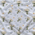 Personalized pale blue swaddle blanket with white daisy bouquets, scattered flowers, green leaves, and the name Charlotte Mae.