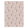 Blush pink blanket with pink gladiolus bouquets, green leaves, and the name Audrey Jane in coral script and green lettering.
