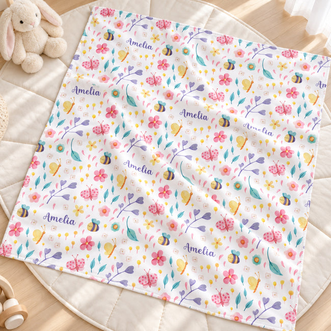 Personalized bee and butterfly baby girl blanket with colorful flowers, garden motifs, and a custom name on a white background.