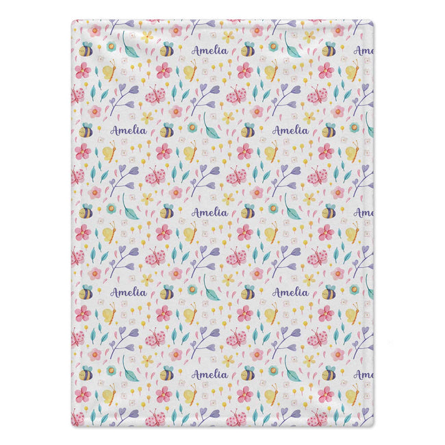 Personalized bee and butterfly baby girl blanket with colorful flowers, garden motifs, and a custom name on a white background.