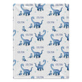 Personalized dinosaur baby boy blanket featuring blue dinosaurs and a custom name on a white background.