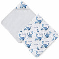 A square baby towel shown from two angles on a white background. One side shows a soft white reverse, and the other shows a white front printed with blue dinosaurs and the name 'COLTON' repeated in blue text.