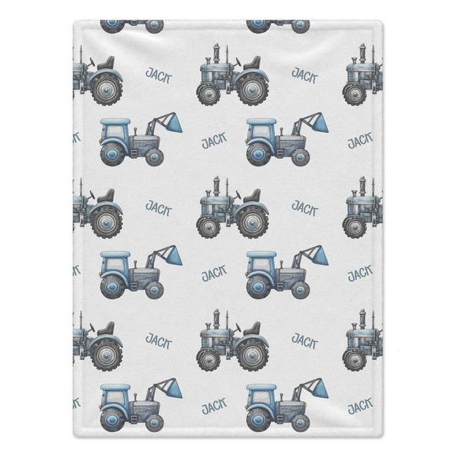 Personalized Blue Tractor Baby Boy Blanket. Blue tractors bring a playful countryside touch to a custom name on a white background.
