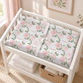 Blush Rose Garden personalized changing pad cover with pink watercolor roses and sage leaves on a white nursery changing ta