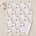 Blush Rose Garden blanket personalized with Elizabeth Rose, laid on a cream rug beside a bunny toy, with one corner folded back.