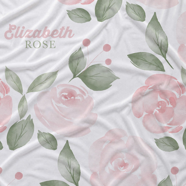 Close-up of Blush Rose Garden fabric with pink watercolor roses, sage leaves, and Elizabeth Rose in pink and green lettering.