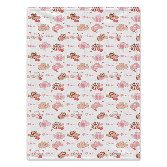 Personalized Cowgirl Hat Baby Girl Blanket. Pink cowgirl hats and sweet bows bring a little western charm to a custom name.