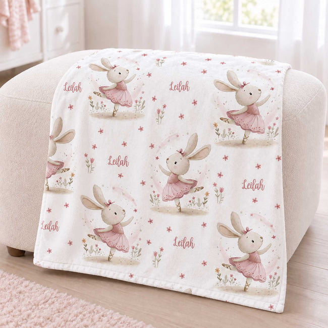 Personalized Ballet Bunny Baby Girl Blanket. Sweet dancing bunnies in soft pink ballet outfits bring storybook charm to a custom name.