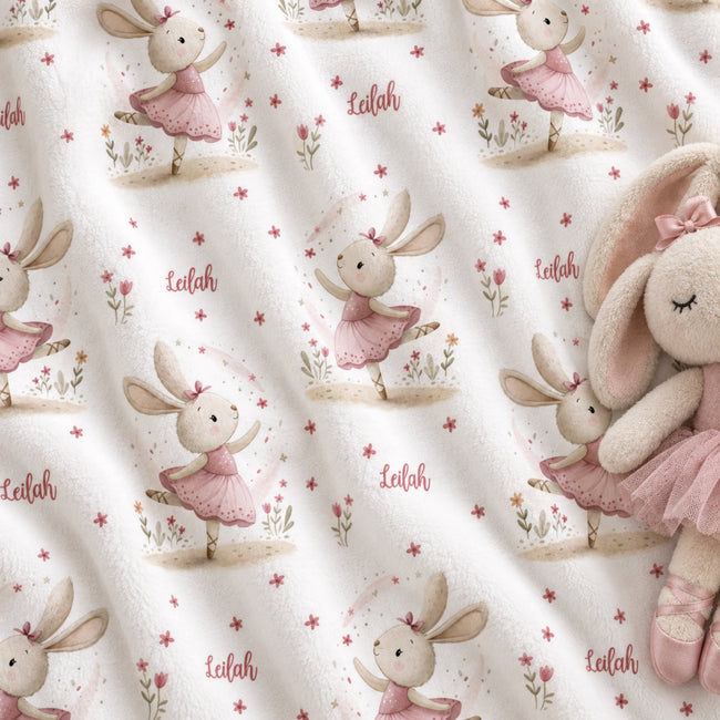 Personalized Ballet Bunny Baby Girl Blanket. Sweet dancing bunnies in soft pink ballet outfits bring storybook charm to a custom name.
