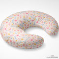 A U-shaped nursing pillow with a light pink floral pattern and the name 'Amelia' printed repeatedly in blue script, shown on a clean white background.