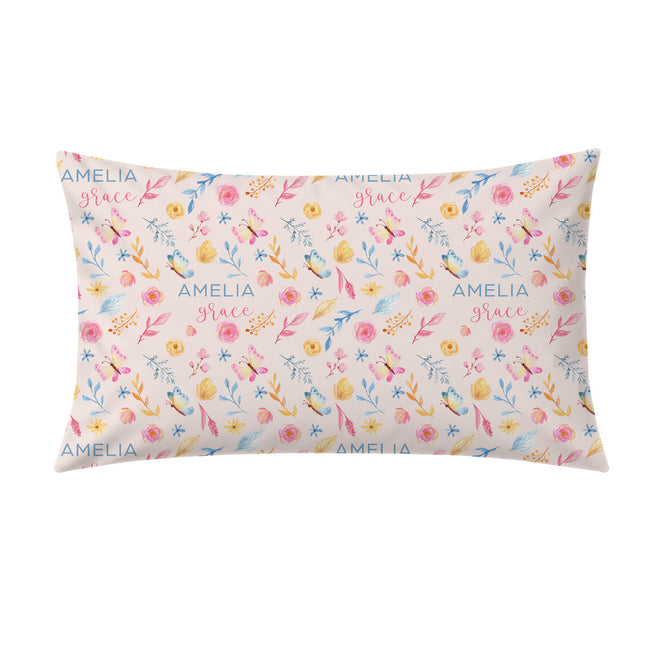 A rectangular decorative pillow with a pastel floral pattern and the words 'AMELIA grace' printed repeatedly, shown on a plain white background.
